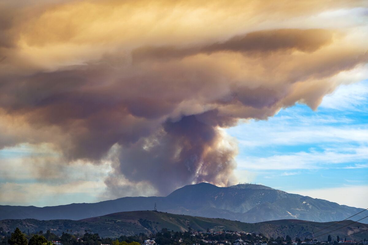 A fire burns in the Cleveland National Forest in this view from Orange, Calif., on Wednesday, March 2, 2022. Crews were battling a roughly 400-acre wildfire reported near the Holy Jim Trail in the Cleveland National Forest on Wednesday. (Mark Rightmire/The Orange County Register via AP)