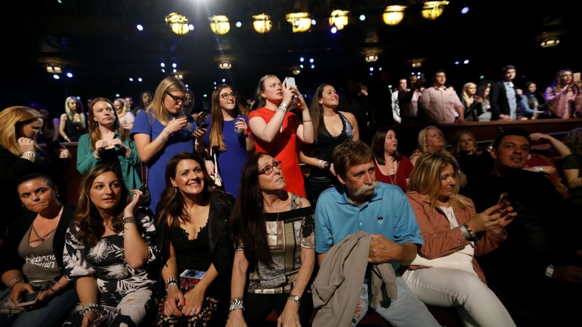 Audience members watch a taping of "Watch What Happens Live With Andy Cohen, " Bravo's popular talk show, at the Wiltern Theatre in Los Angeles.