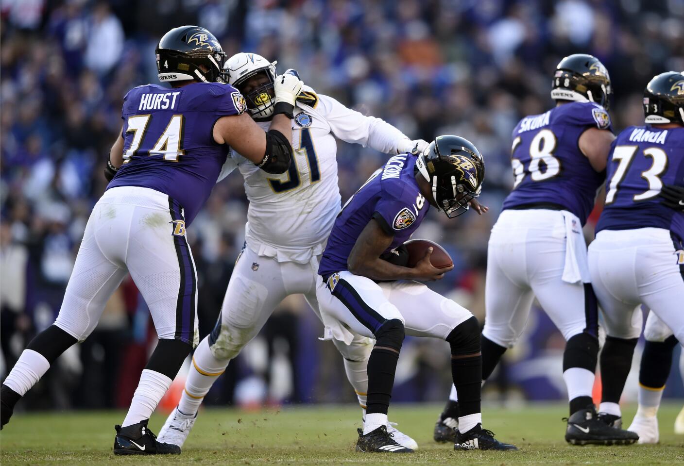 Baltimore Ravens quarterback Lamar Jackson (8) is sacked by Los Angeles Chargers defensive tackle Justin Jones (91) in the second half of an NFL wild card playoff football game, Sunday, Jan. 6, 2019, in Baltimore.