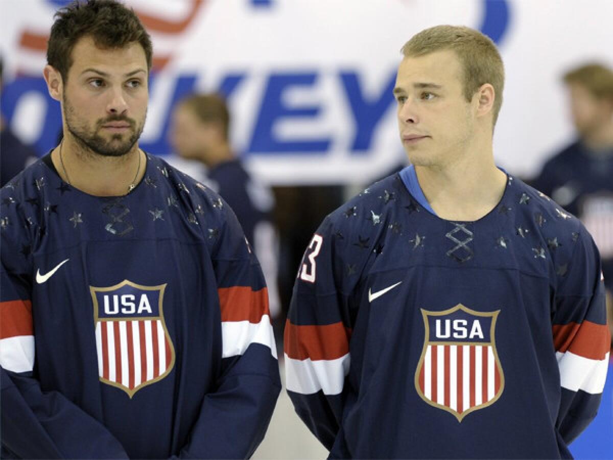 Members of the 2013 USA Hockey Men's National Team, Zach Bogosian, left, of the Winnipeg Jets, and Dustin Brown, Kings, wear the newly unveiled team jersey on Tuesday.
