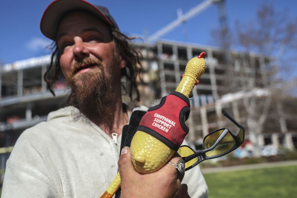 Scott Vicki holds his "emotional support chicken." 