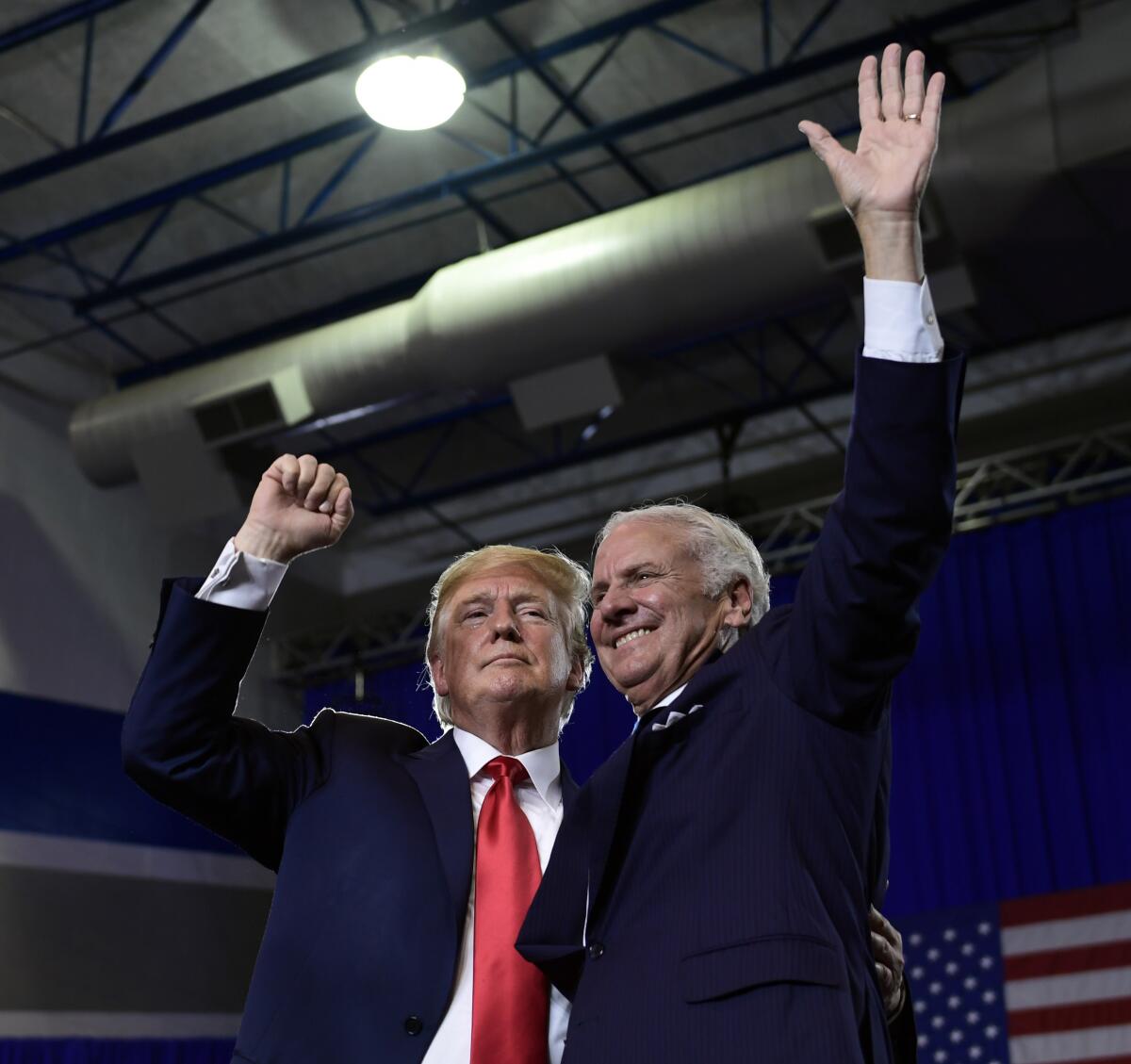FILE - In this Monday, June 25, 2018 file photo, President Donald Trump speaks during a rally at Airport High School in West Columbia, S.C. for Republican Gov. Henry McMaster, right. Former President Donald Trump on Friday, March 5, 2021 endorsed South Carolina Gov. Henry McMaster's bid for a second full term in 2022, continuing their yearslong alliance in a move to strengthen ties with the early-voting state that Trump won twice. (AP Photo/Susan Walsh, File)