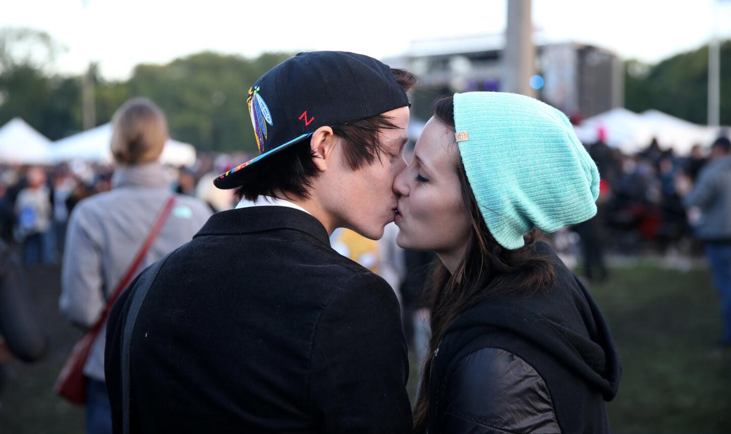 Gavin Christopherson and Kacy Appelgren share a kiss at Riot Fest in Chicago's Humboldt Park on Saturday, September 13, 2014.