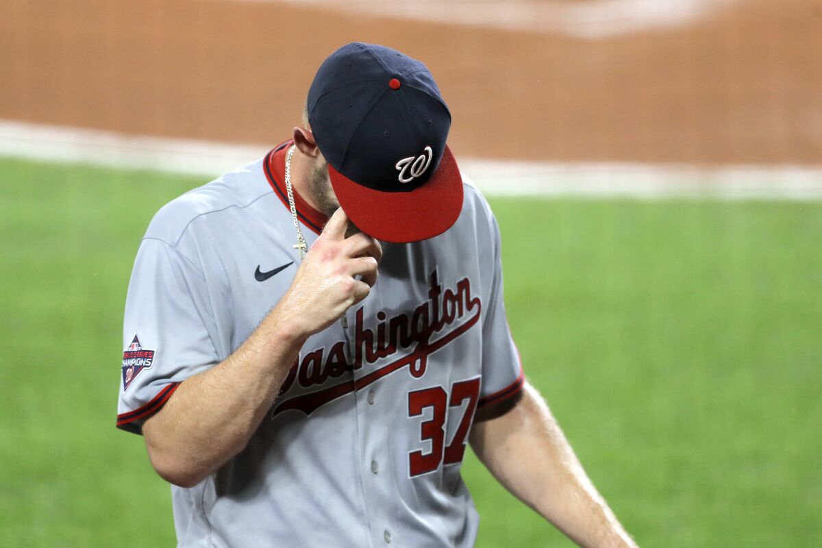 Washington Nationals starting pitcher Stephen Strasburg heads to the dugout after leaving the game during the first inning of a baseball game against the Baltimore Orioles, Friday, Aug. 14, 2020, in Baltimore. (AP Photo/Julio Cortez)