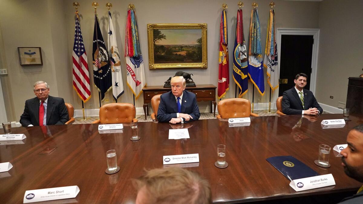 Trump tried to capitalize on Sen. Charles Schumer and Rep. Nancy Pelosi's snub, sitting between two empty chairs with their name cards. Senate Majority Leader Mitch McConnell, left, and House Speaker Paul D. Ryan, right, usually sit in those seats but instead occupied the ends.