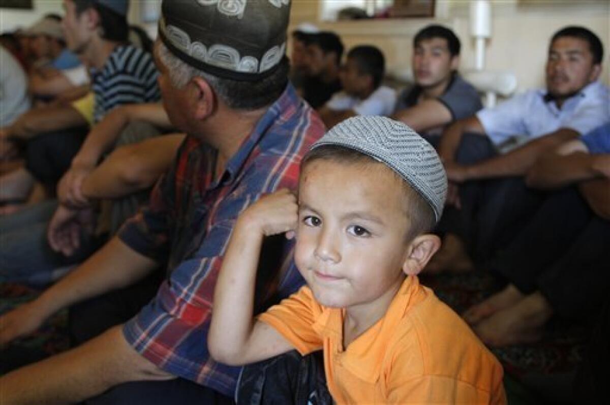 An ethnic Uzbek boy is seen prior a Friday prayer in mosque in Vlksm, the Uzbek neighborhood near the southern Kyrgyz city of Osh, Friday, June 18, 2010. The United Nations said as many as 1 million people may need aid in Kyrgyzstan and Uzbekistan, including the potential number of refugees, internally displaced, host families and others that may suffer in one way or another from the unrest. (AP Photo/Sergei Grits)