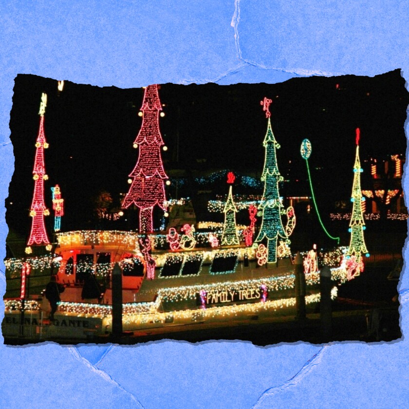A boat covered with Christmas lights including some in the shape of trees. 