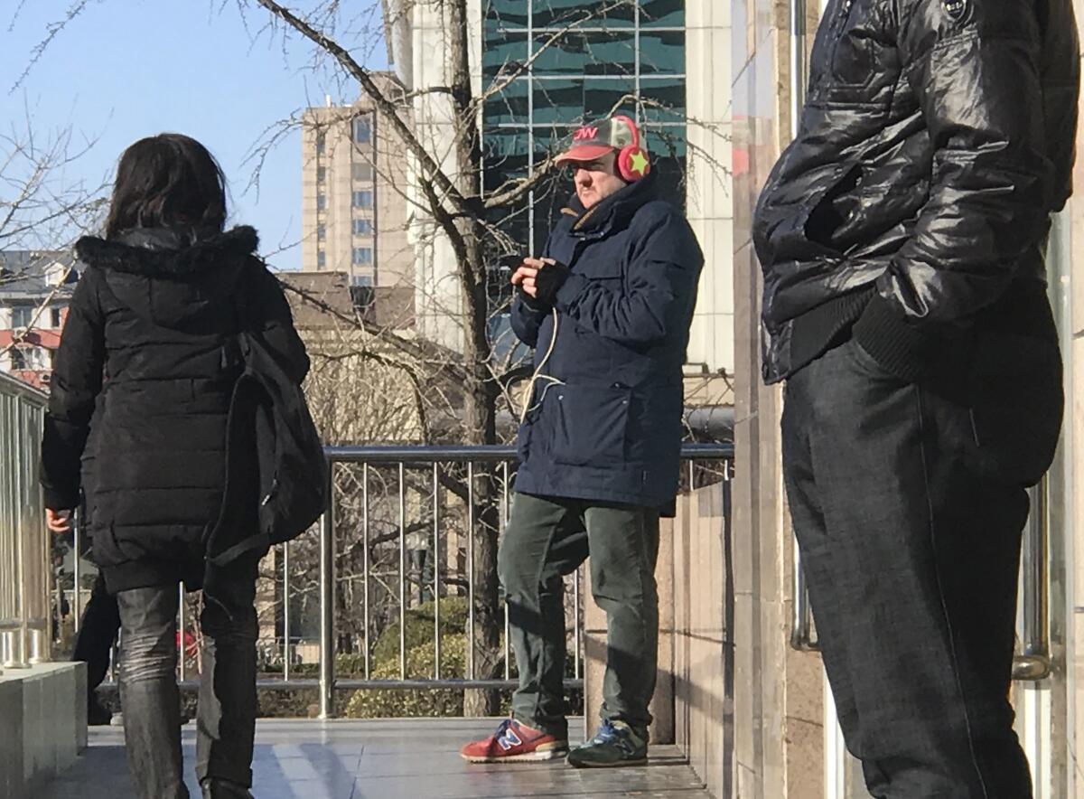 CNN cameraman outside a train station in Beijing
