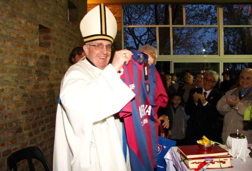 Pope Francis, then known as Cardinal Jorge Mario Bergoglio, shows off the jersey the San Lorenzo soccer team in Buenos Aires.