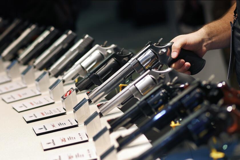FILE - In this Jan. 19, 2016, file photo, handguns are displayed at the Smith & Wesson booth at the Shooting, Hunting and Outdoor Trade Show in Las Vegas. The Mexican government sued U.S. gun manufacturers and distributors, including some of the biggest names in guns like Smith & Wesson Brands, on Aug. 4, 2021 in U.S. federal court in Boston, arguing that their commercial practices have unleashed tremendous bloodshed in Mexico. (AP Photo/John Locher, File)