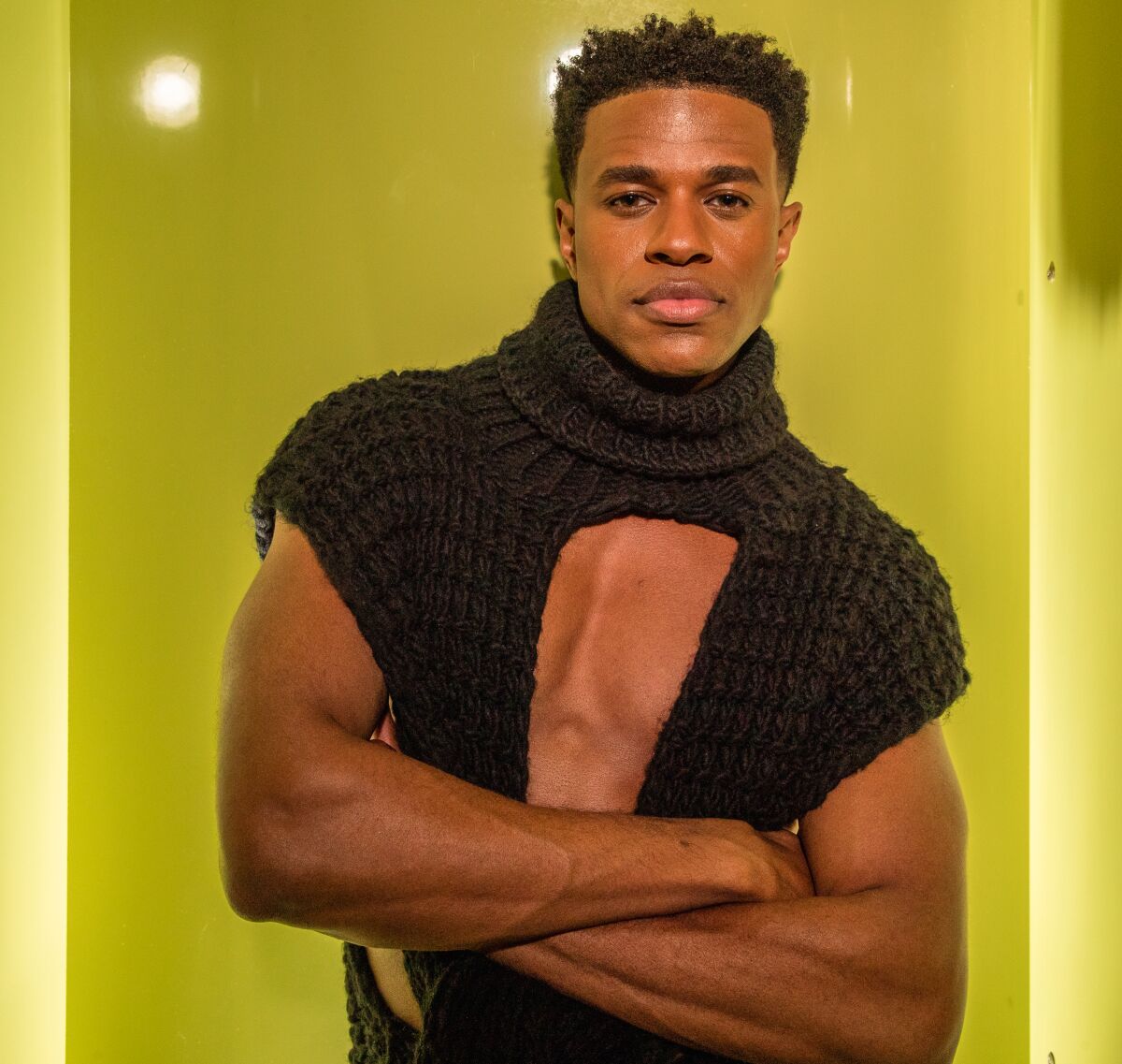 Jeremy Pope poses for a portrait in black sweater that bares his chest.