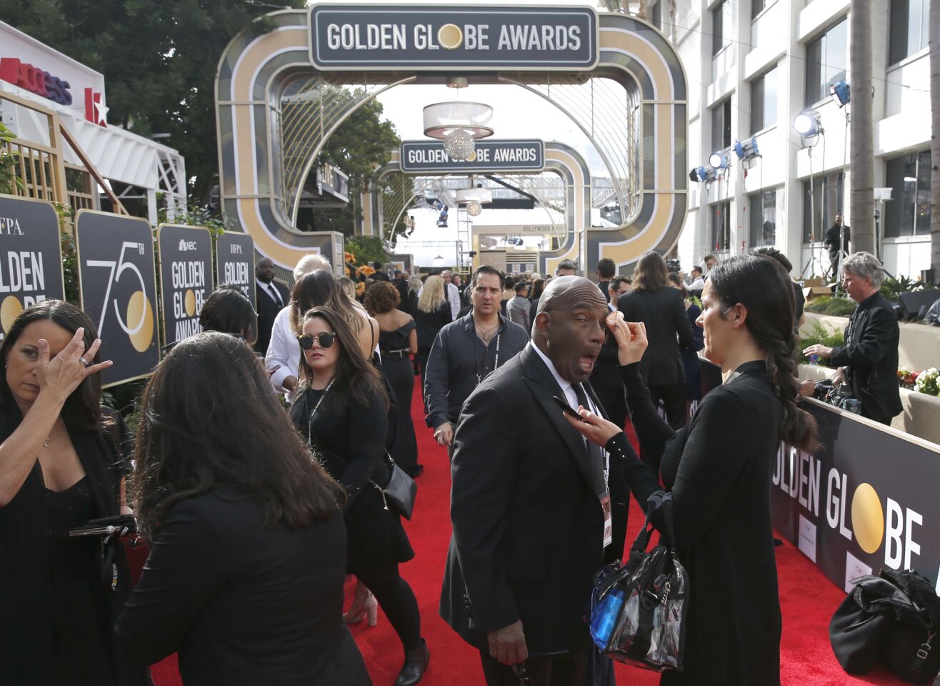 Al Roker gets a last-minute touch-up on the red carpet during arrivals at the 75th Golden Globes at the Beverly Hilton Hotel.