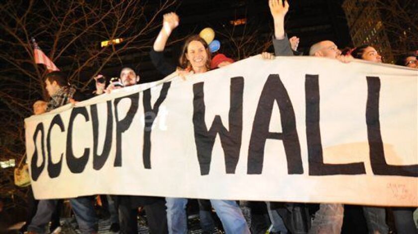 Occupy Wall Street protesters celebrate in Zuccotti Park in New York in 2011, while standing on barricades they removed from around the park.