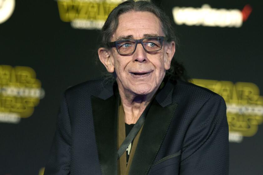 FILE - In this Dec. 14, 2015, file photo, Peter Mayhew arrives at the world premiere of "Star Wars: The Force Awakens" in Los Angeles. Mayhew, who played the rugged, beloved and furry Wookiee Chewbacca in the Star Wars films, has died. Mayhews family said in a statement that he died at his home in Texas on Friday, April, 26, 2019. He was 74. No cause was given. (Photo by Jordan Strauss/Invision/AP, File)