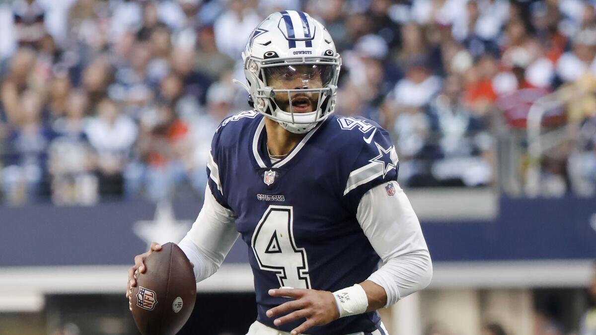Dallas Cowboys quarterback Dak Prescott looks to throw during a game.