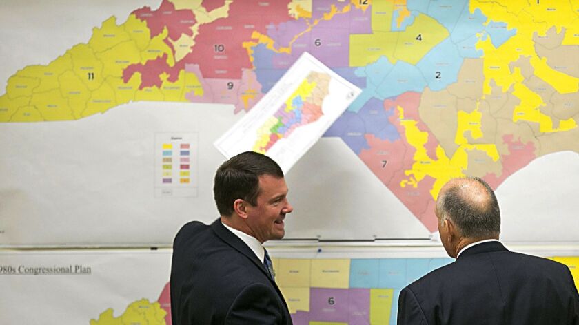 North Carolina state Sen. Brent Jackson, right, and then-Sen. Dan Soucek, both Republicans, review historical district maps in 2016.