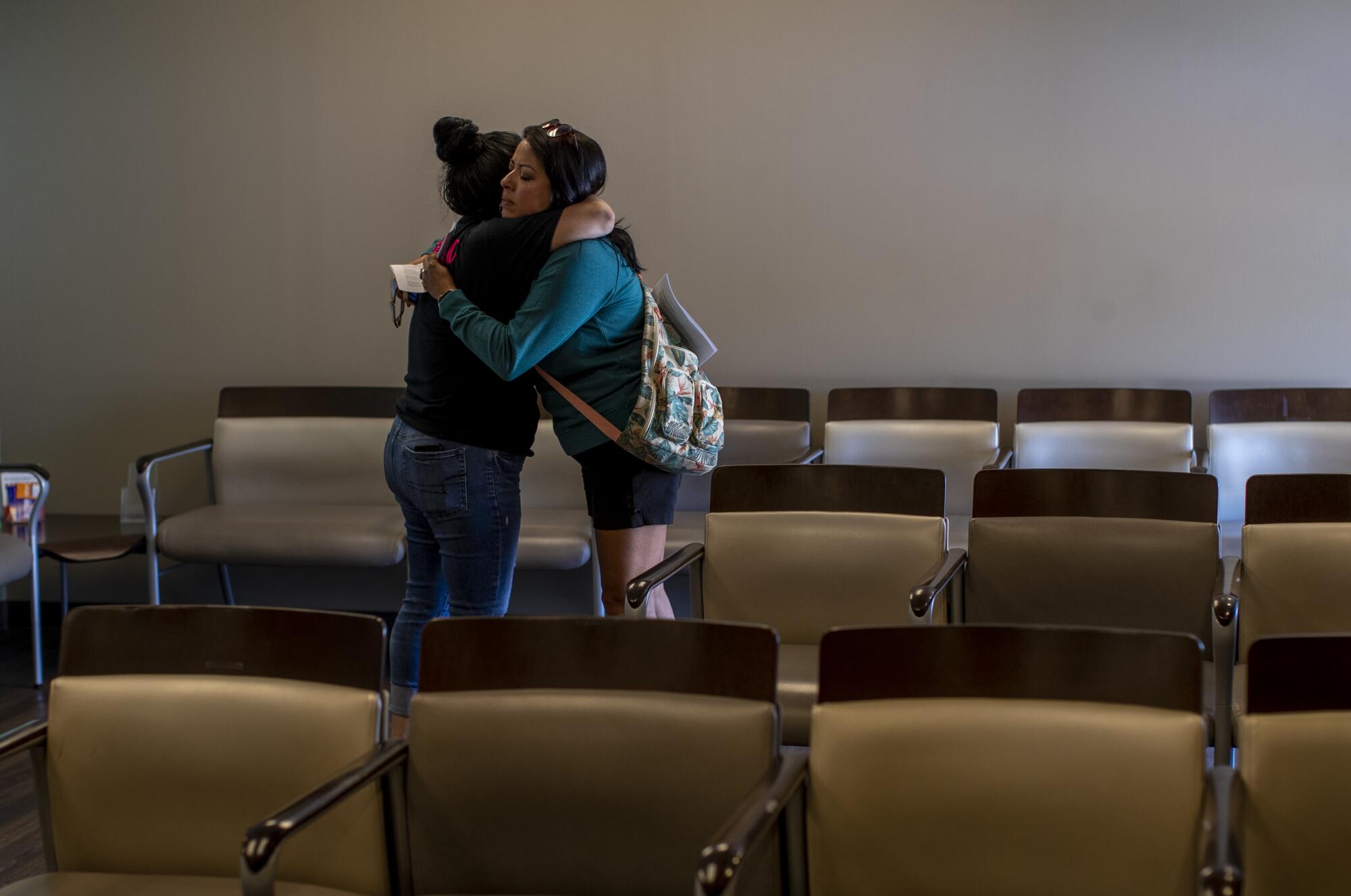A teary staff member hugs a patient after informing her the clinic could no longer provide abortion services 