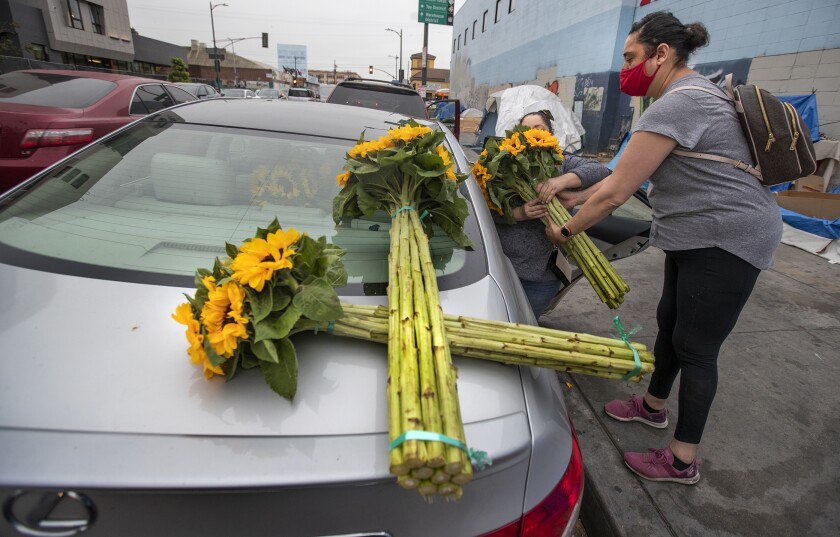 A flower shortage is driving up costs for a Mother's Day of
post-COVID-19 reunions 5 Women put flowers in car
