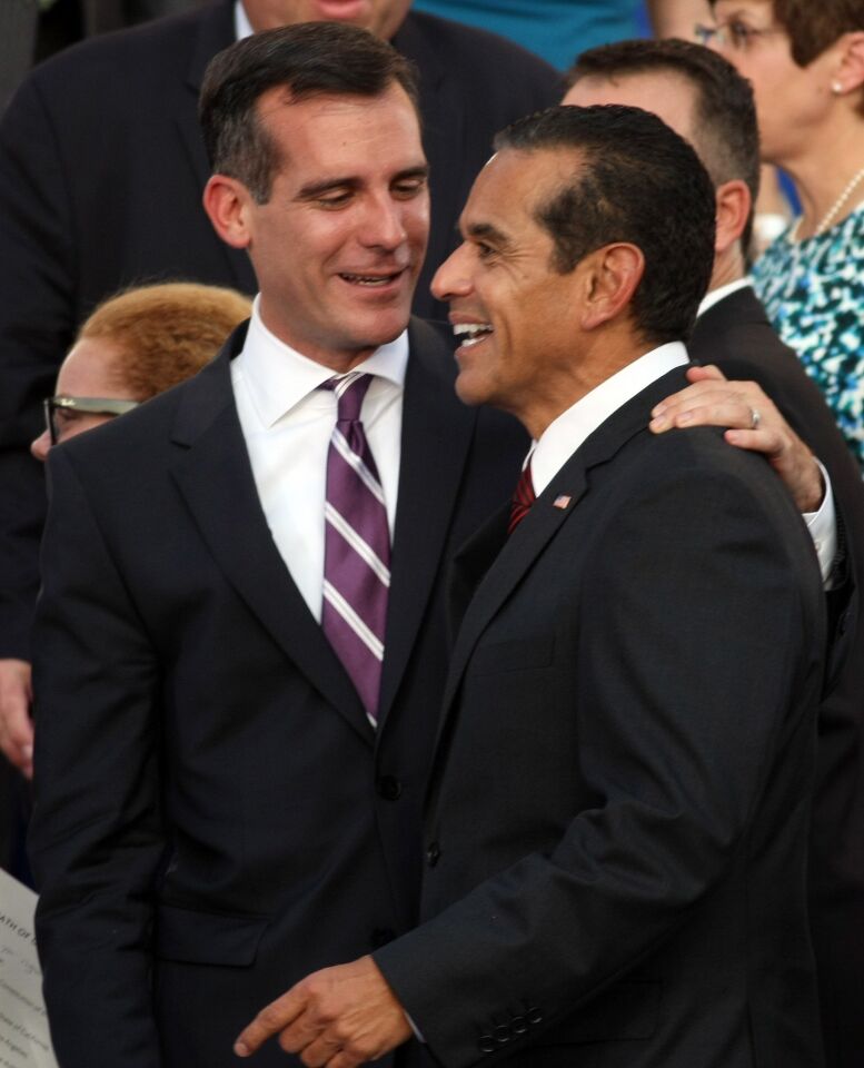 Eric Garcetti, left, enjoys a light moment with former Los Angeles Mayor Antonio Villaraigosa after being sworn in. Garcetti, 42, thanked his predecessor for leaving the city "safer, greener and stronger."