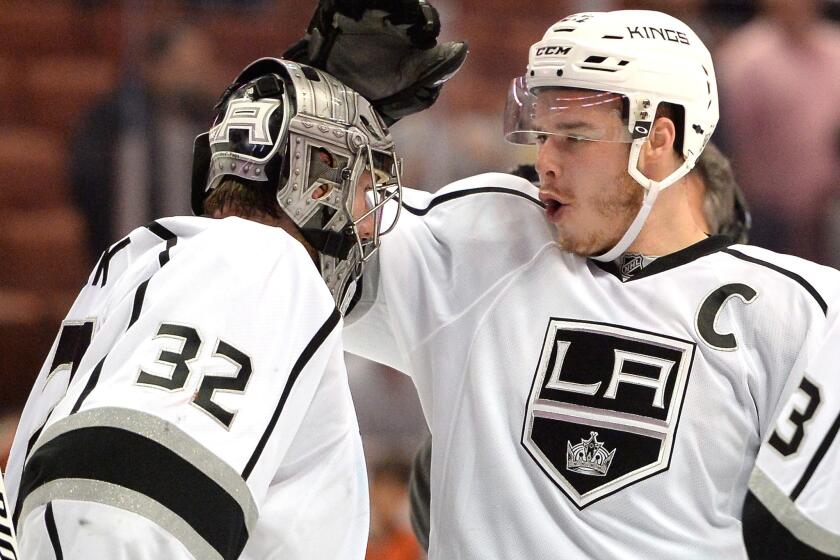 The Kings' Dustin Brown, right, celebrates Game 2 win over the Ducks with goaltender Jonathan Quick, left, on May 5.