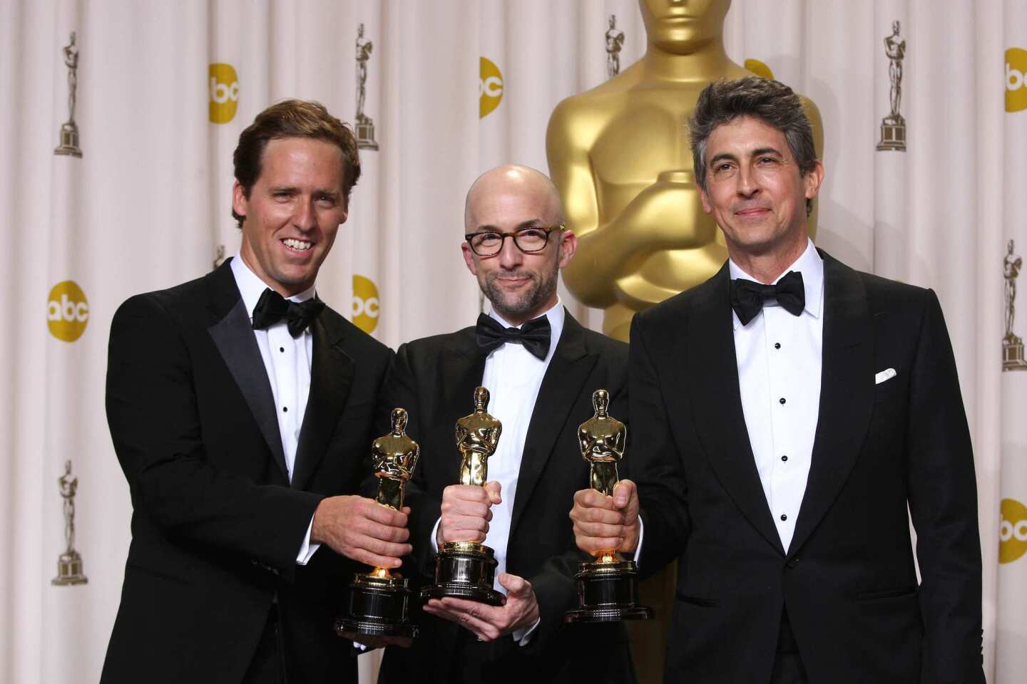 Adapting "The Descendents," based on Kaui Hart Hemmings' novel of the same name, was a fluid, organic process, said Alexander Payne, right, backstage after the film won the Oscar for adapted screenplay. Screenwriters Jim Rash, left, and Nat Faxon, he says, gave him myriad directions to take the material in. "They paved a path for me because they'd been through the book quite a few times," said Payne. "They gave me the luxury to pick and choose what I responded to. What I didn't keep was as much screen time with the younger daughter."