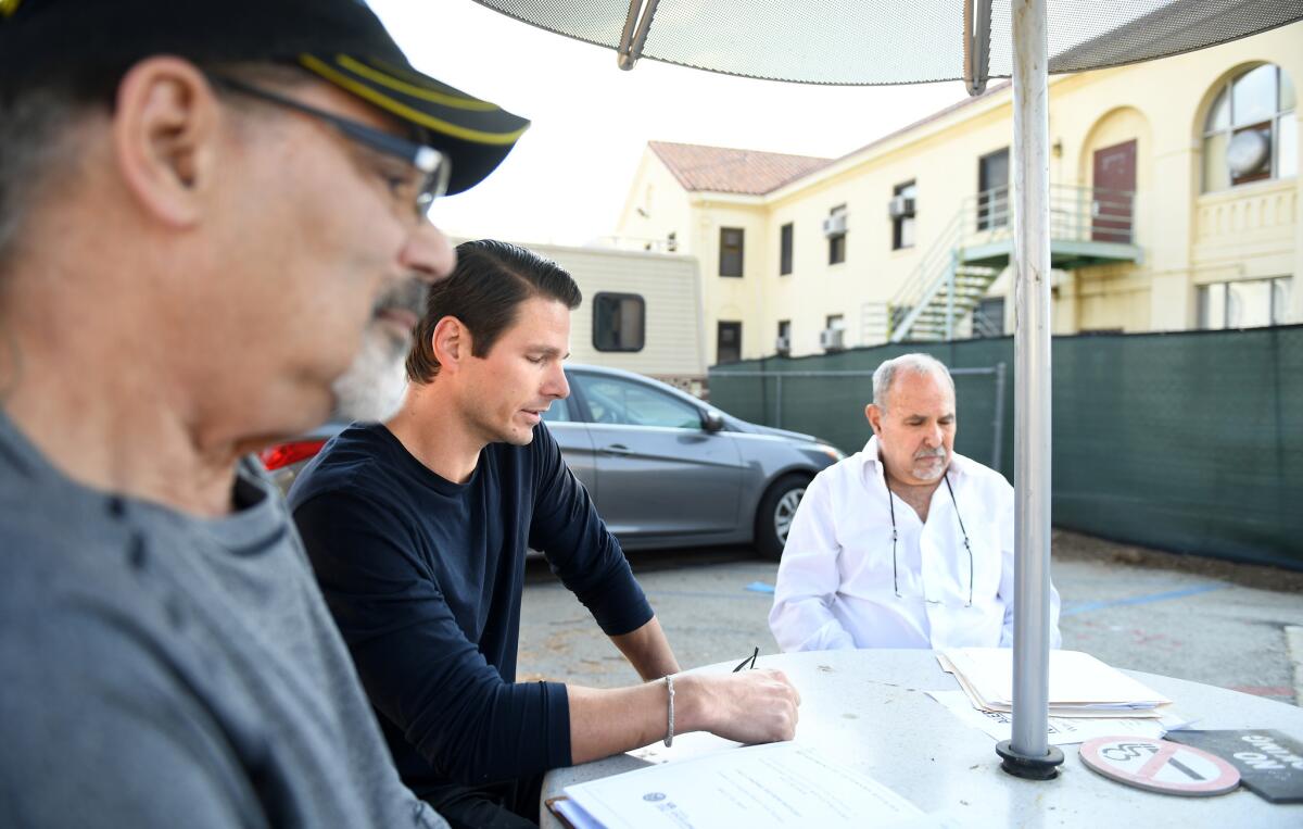 Veterans Steven Goldstein, from left, Peter Erdos and Dov Simens sit outside building 256 at the West Los Angeles Healthcare Center.