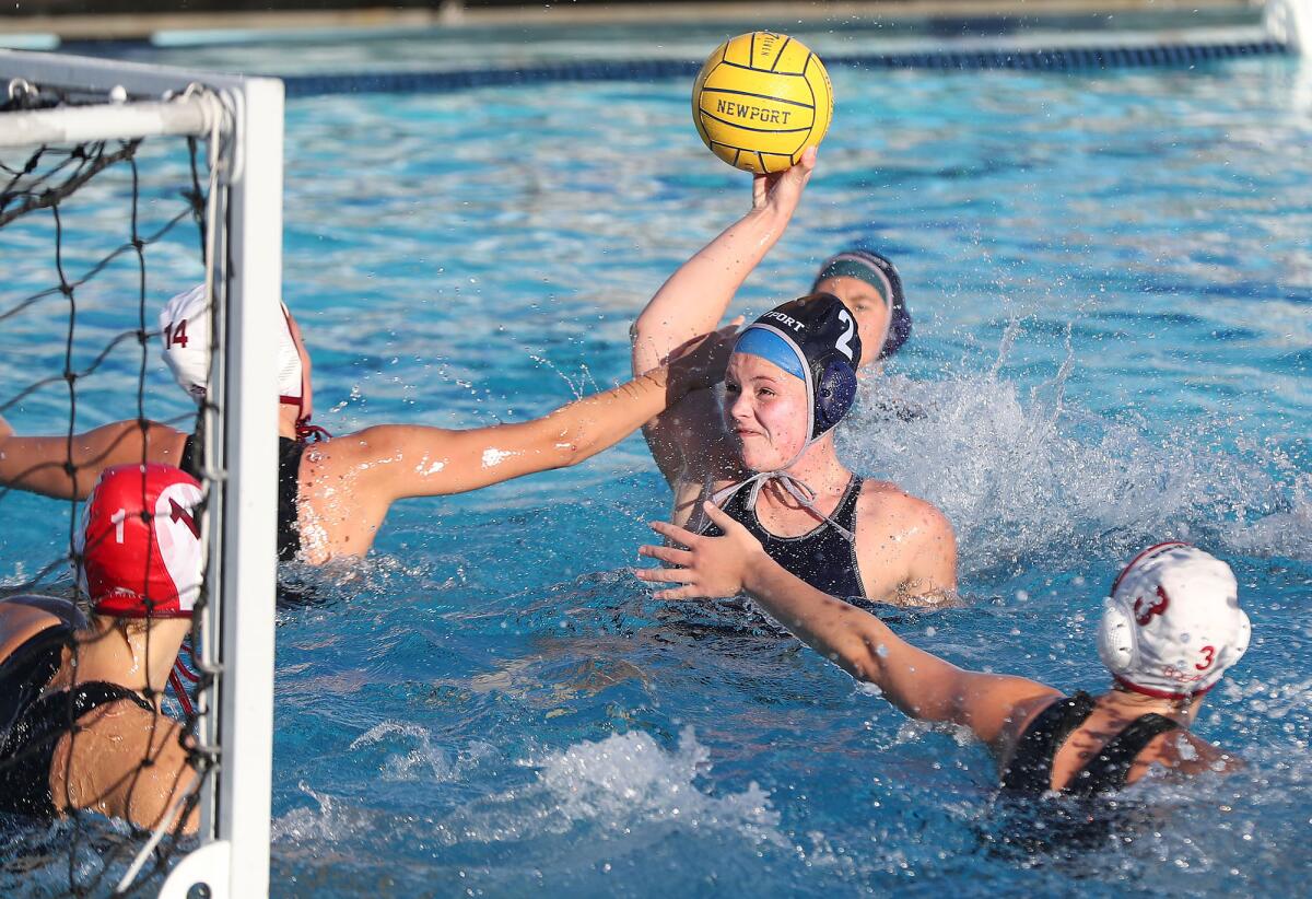 Newport Harbor's Harper Price tries to get a shot off as Laguna Beach's Sophie Colladay defends.