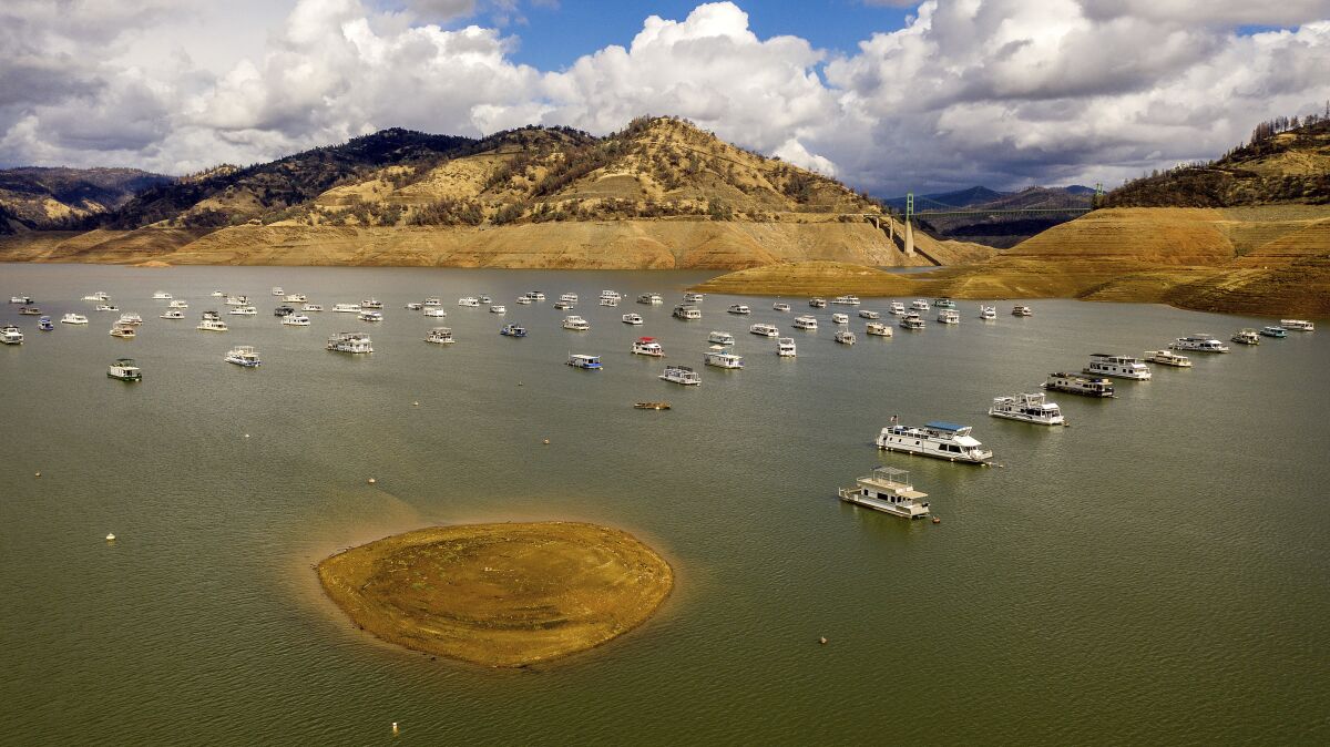 Houseboats float on Lake Oroville, Monday, Oct. 25, 2021, in Oroville, Calif. 