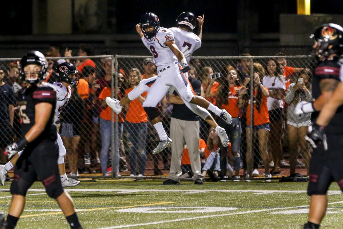 Chaminade's Michael Wilson (9) celebrates with Brevin White (7) after a touchdown against Oaks Christian on Aug. 26.