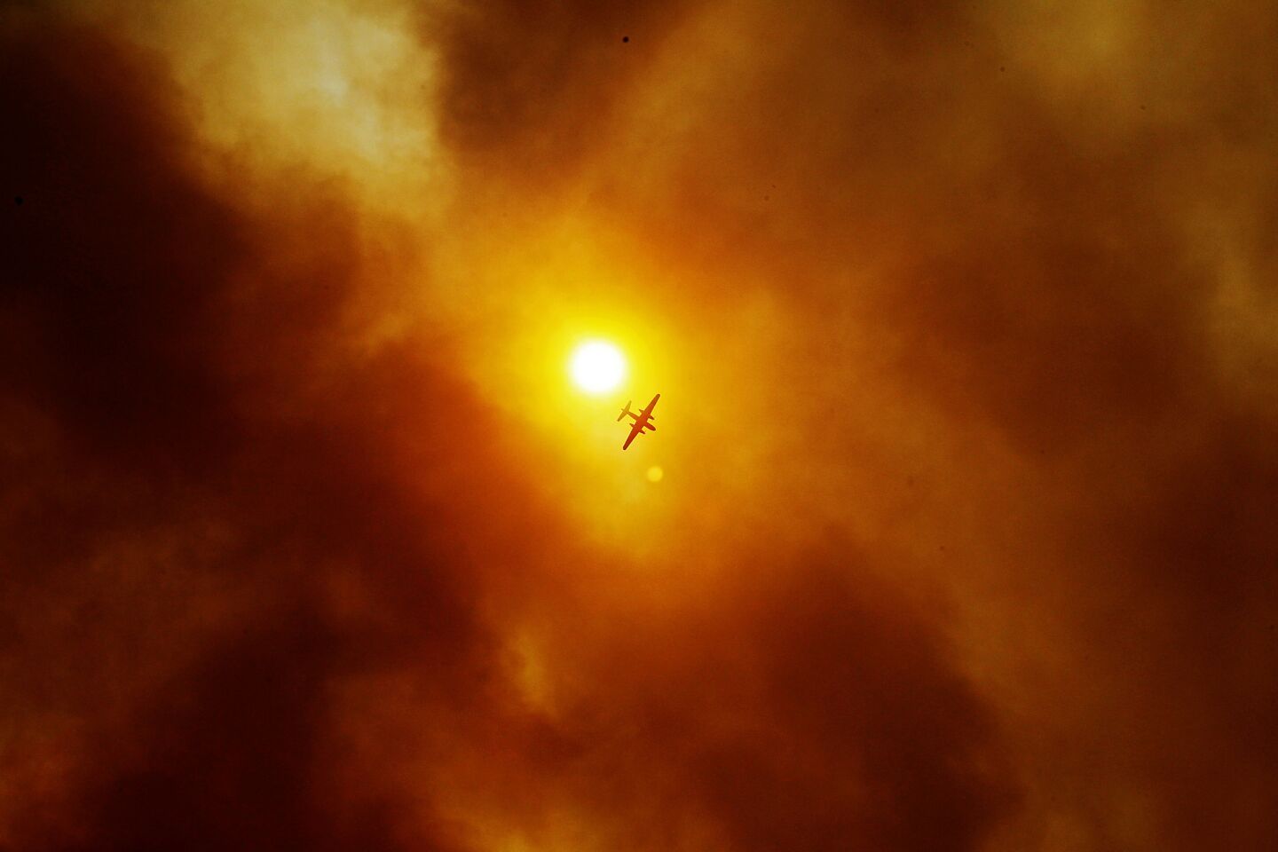 Thick smoke nearly obscures the sun above San Marcos, where the wildfire continues to burn.
