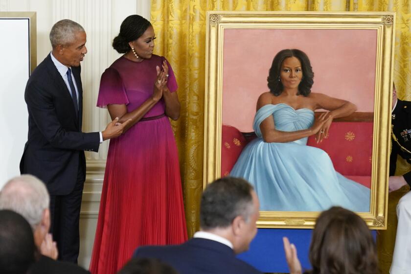 Former President Barack Obama and former first lady Michelle Obama look at the former first lady's official White House portrait after she unveiled it during a ceremony in the East Room of the White House, Wednesday, Sept. 7, 2022, in Washington. (AP Photo/Andrew Harnik)