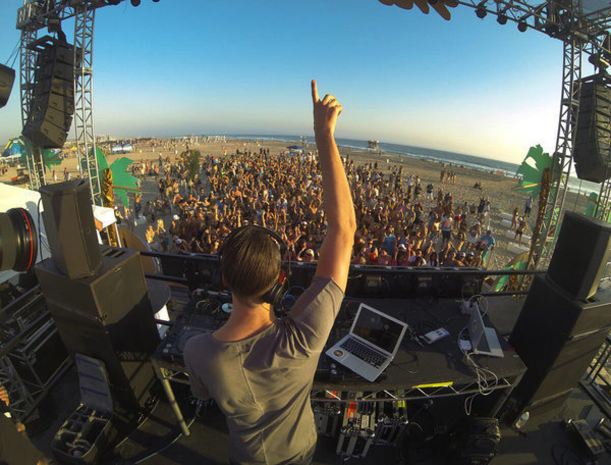 DJ Mak J of Los Angeles gets the crowd going at an all-day rave at Huntington Beach on Sept. 14. More than 100 people were arrested on mostly alcohol- and drug-related charges at a Bay Area rave over the weekend.
