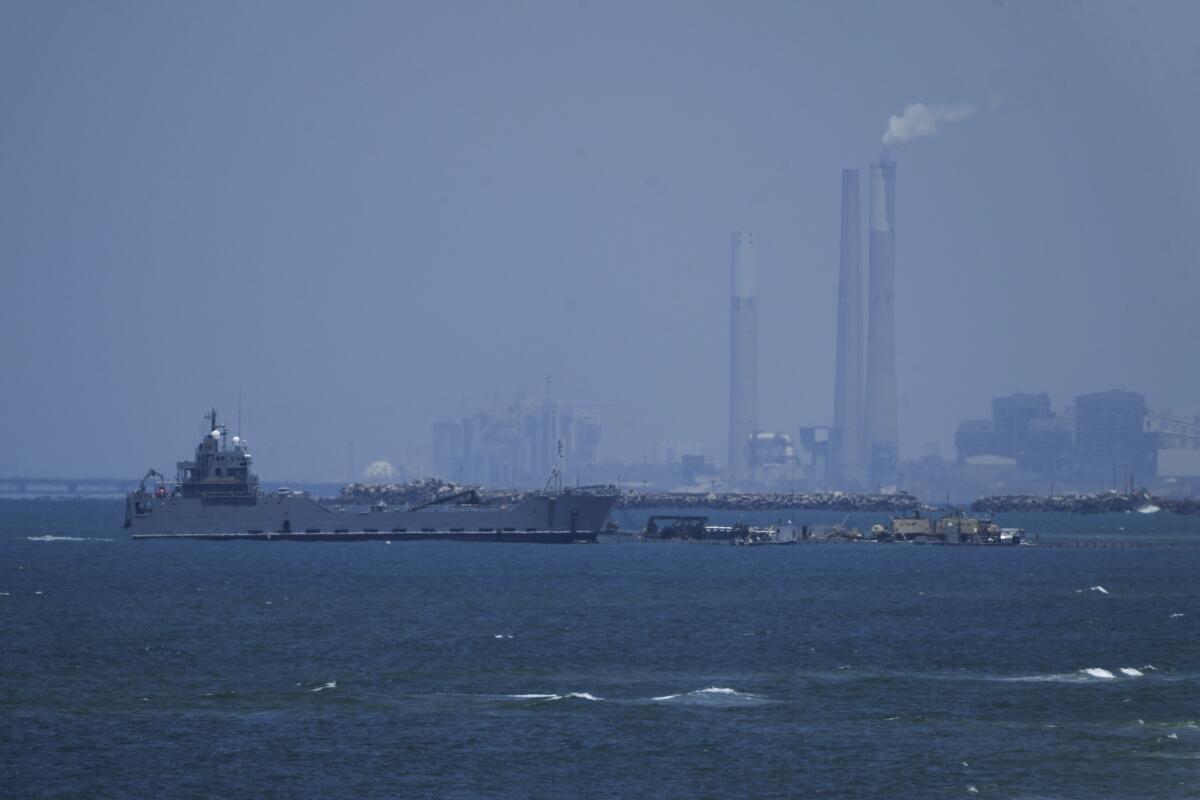 A ship is seen off the coast of Gaza near a U.S.-built floating pier