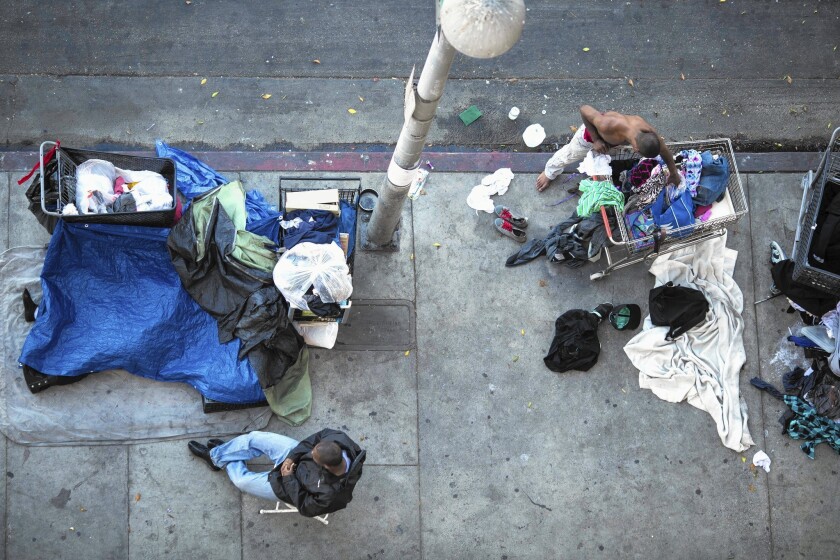 In their latest census, Los Angeles police counted more than 1,700 people living in tents and cardboard boxes in the 50-block skid row area. Above, people sit and walk on South San Pedro Street.