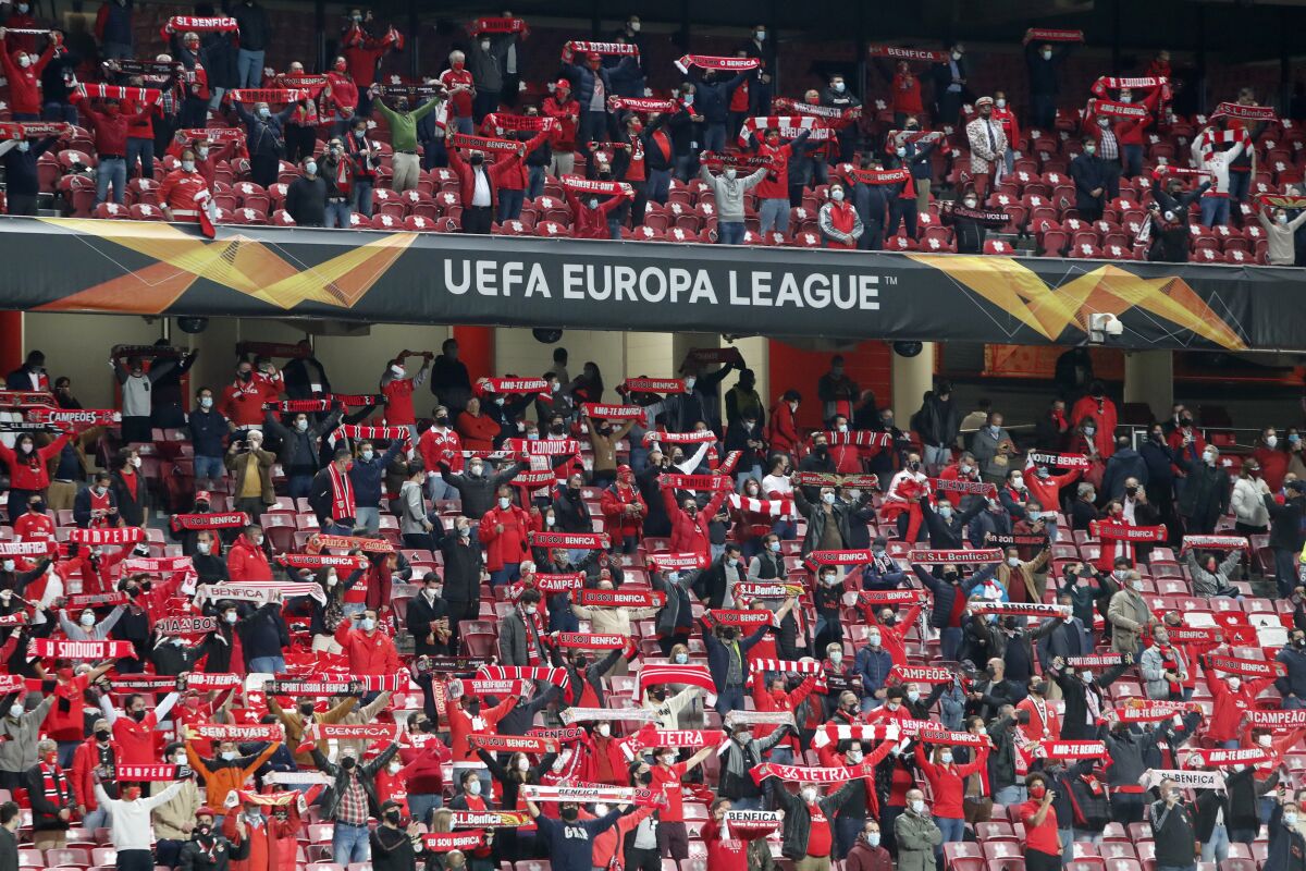 Benfica fans hold up their scarves before the start of the Europa League group D soccer match between Benfica and Standard Liege at the Luz stadium in Lisbon, Thursday, Oct. 29, 2020. (AP Photo/Armando Franca)