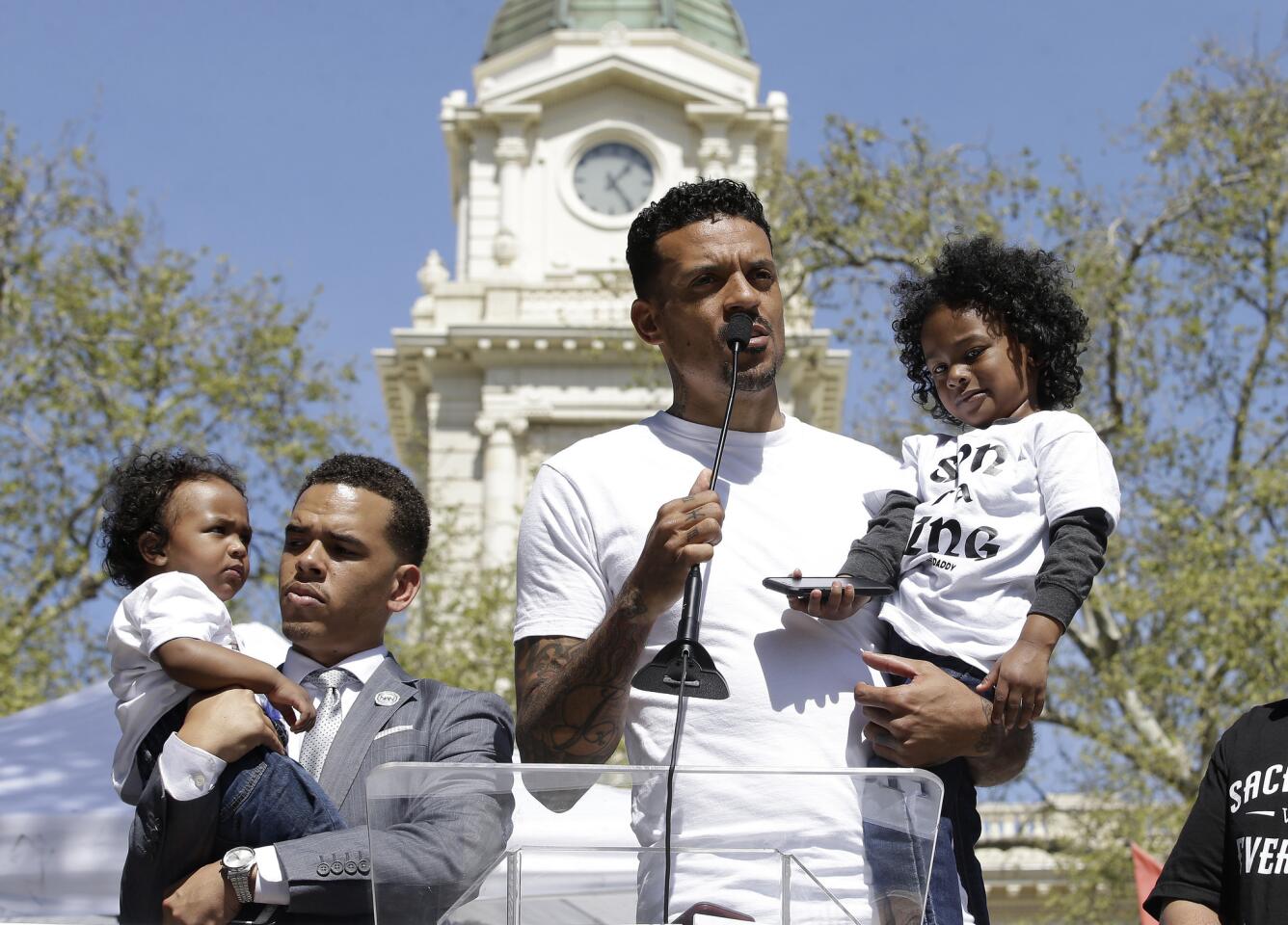 Former NBA player Matt Barnes holds Cairo, one of the sons of police shooting victim Stephon Clark, as he speaks at a rally aimed at ensuring Clark's memory and calling for police reform, Saturday, March 31, 2018, in Sacramento, Calif.