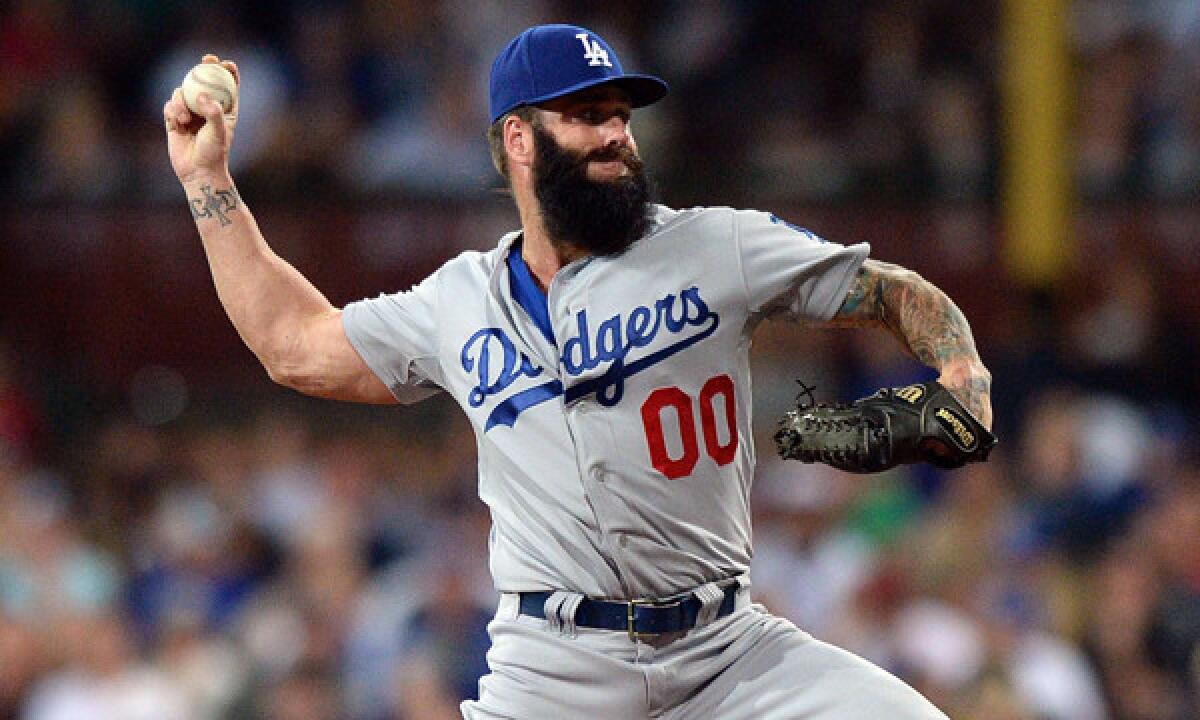 Dodgers reliever Brian Wilson delivers a pitch against the Arizona Diamondbacks on March 22. Wilson is working on building up his arm strength in hopes of becoming a valuable contributor to the Dodgers' bullpen.