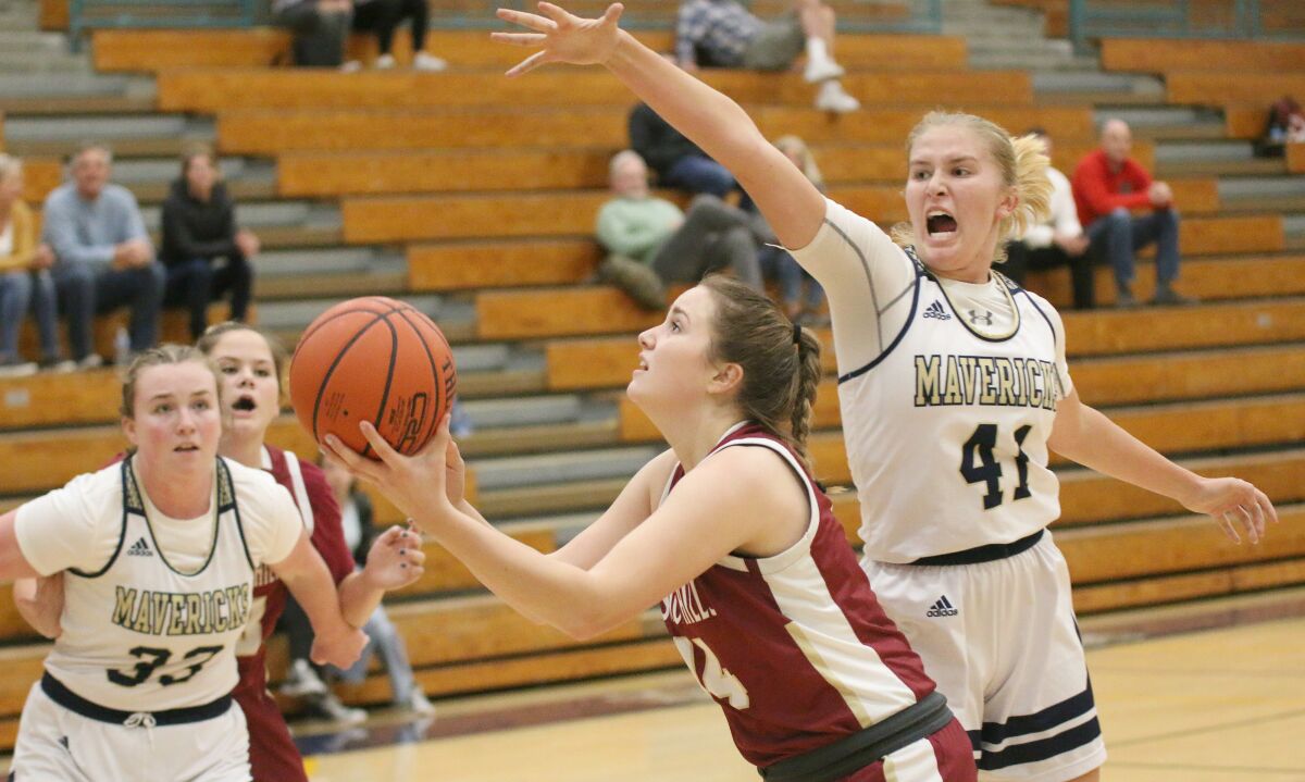 LCC senior Hannah Etheridge challenges Olivia Keltner of Mission Hills.