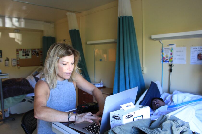 Reporter Joanne Faryon inside the nursing home, using Google translate to try to speak with “66 Garage” in 2015.