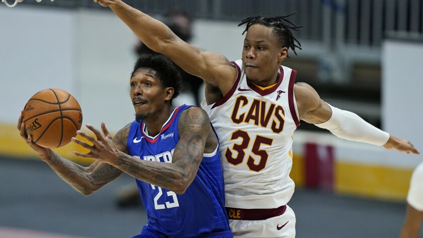 Clippers' Lou Williams drives to the basket against Cleveland Cavaliers' Isaac Okoro.