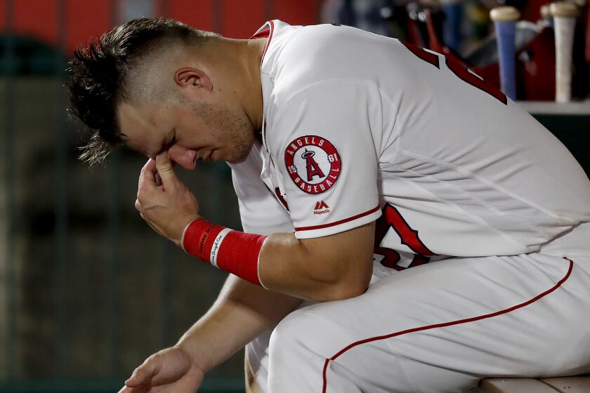 ANAHEIM, CALIF. - AUG. 13, 2019. Angels center fielder Mike Trout sits in the dugout in the ninth inning.