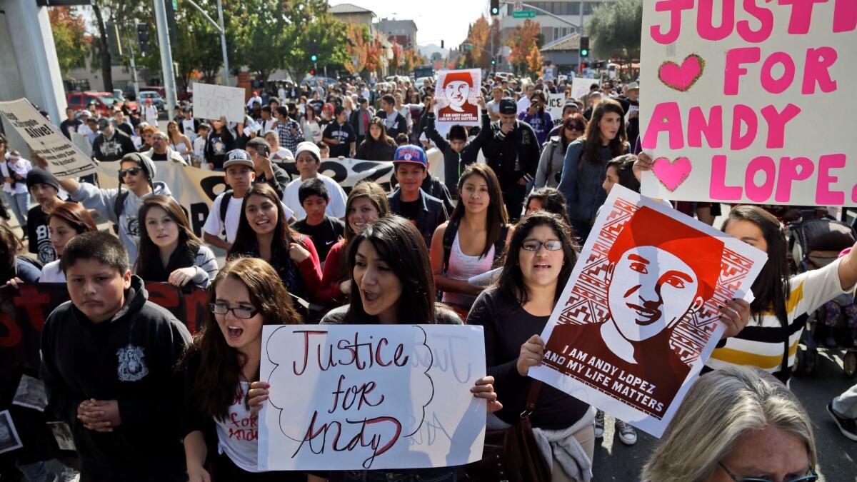 Protesters march in Santa Rosa, Calif., in 2013 to protest the fatal shooting of 13-year-old Andy Lopez by a Sonoma County deputy. A federal appeals court ruled Friday that his family's lawsuit against the deputy and the Sheriff's Department can proceed.