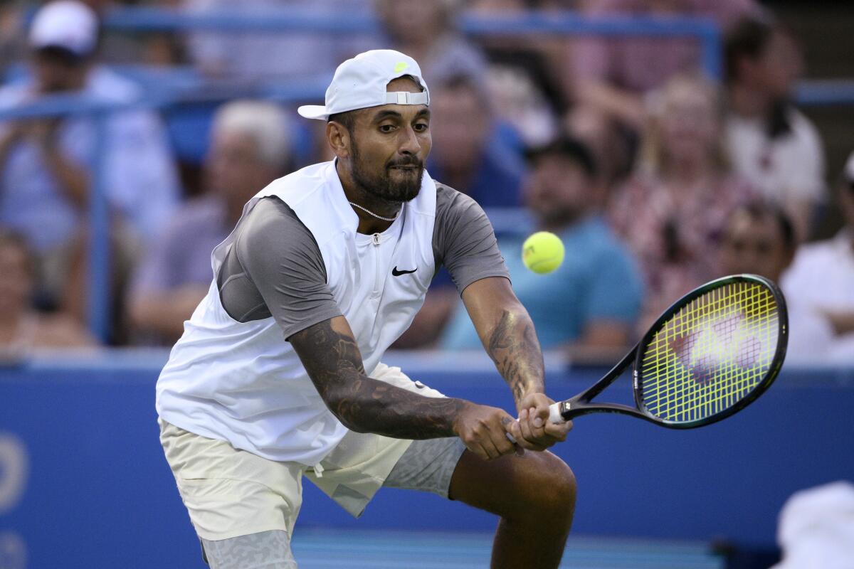 Nick Kyrgios, of Australia, hits a return to Mikael Ymer, of Sweden, during a semifinal at the Citi Open tennis tournament Saturday, Aug. 6, 2022, in Washington. (AP Photo/Nick Wass)