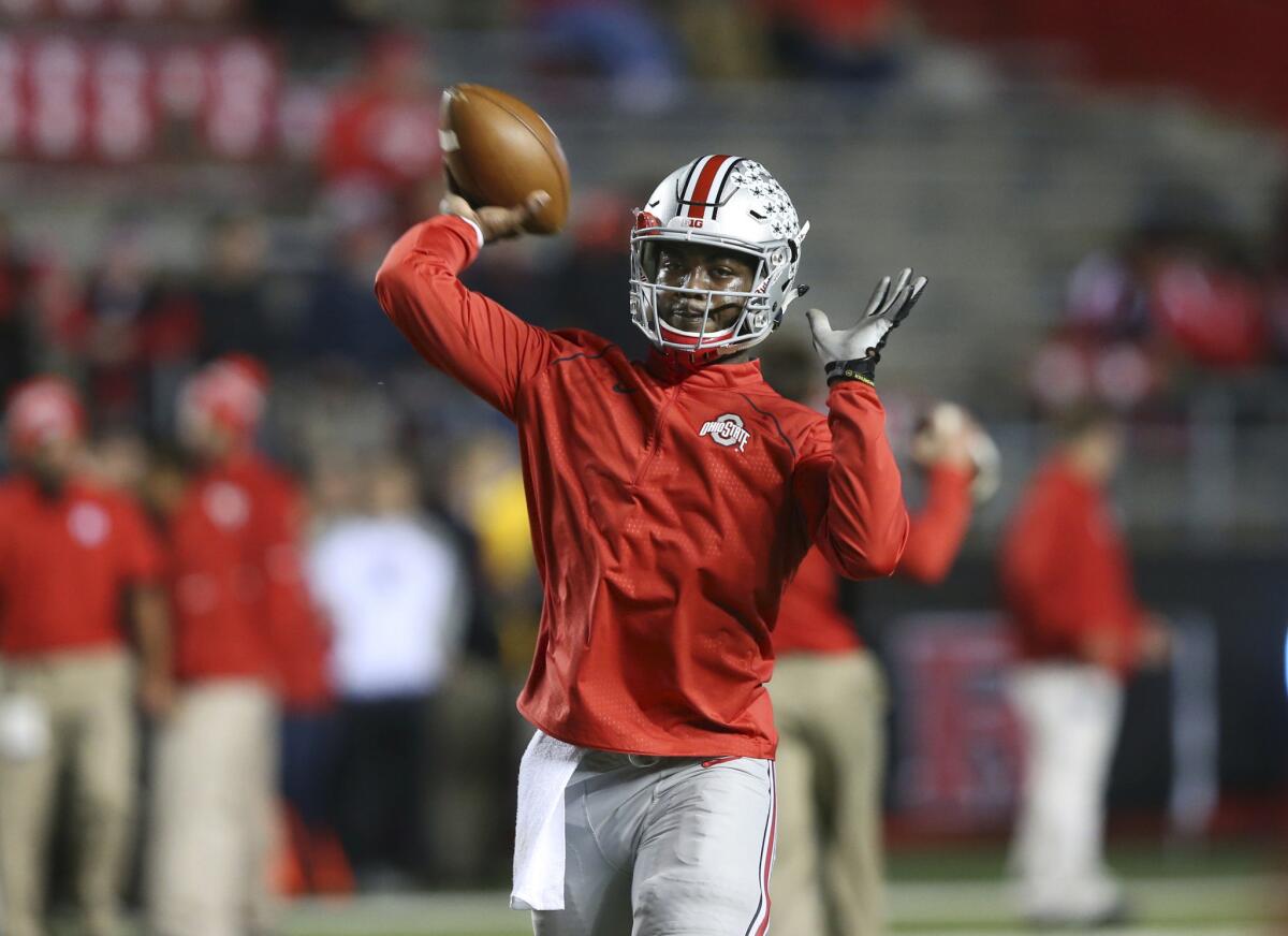Ohio State quarterback J.T. Barrett throws a pass as the team warms up before a game against Rutgers on Oct. 24.