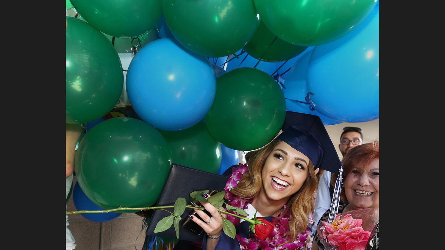 Daily High School graduate Dione Davoodi has to look under a massive bouquet of balloons to hear what was being yelled at her after at the graduation ceremony for the classes of 2017 from Allan F. Daily High School and Verdugo Academy at First United Methodist Church in Glendale on Thursday, June 1, 2017.