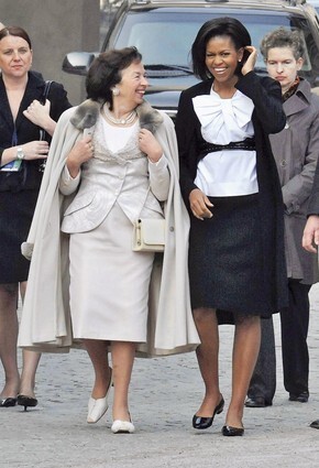 First Lady Michelle Obama walks with her Czech counterpart Livia Klausova at the St. Vitus Chatedral at Hradcany Square of Czech capital, during the second day of President Obama's official visit. Michelle wears a white bow blouse by Moschino, a Michael Kors black pencil skirt and her signature Azzedine Alaia belt.
