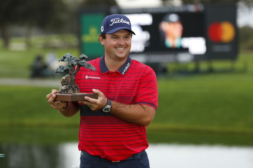 SAN DIEGO, CA - JANUARY 31: Patrick Reed shot a 14 under to win the Farmers Insurance Open, shown during a socially distanced trophy ceremony at Torrey Pines on Sunday, Jan. 31, 2021 in San Diego, CA. (K.C. Alfred / The San Diego Union-Tribune)