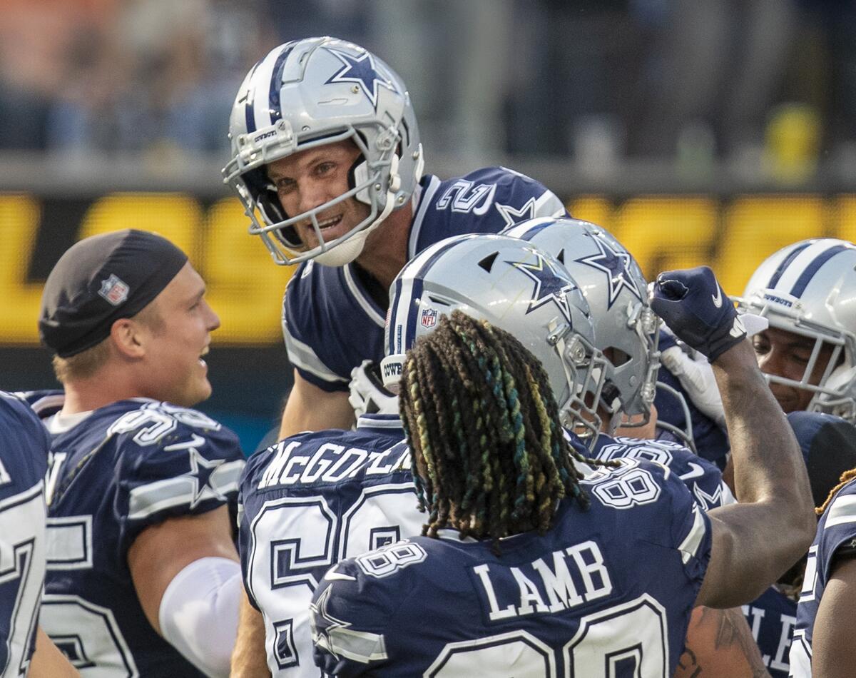 Dallas Cowboys kicker Greg Zuerlein is hoisted up by his teammates after kicking the winning field goal Sunday.