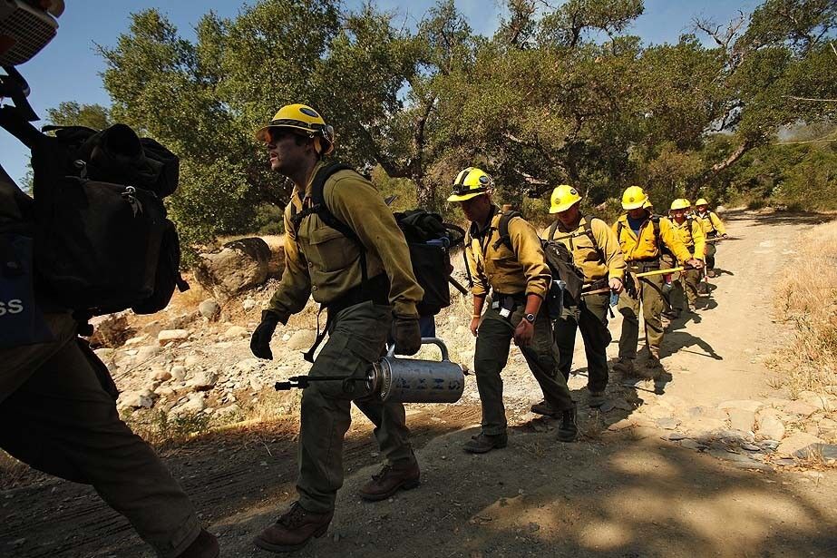 Rio Bravo Hotshots walk through the Upper Oso camping area in the Los Padres National forest.