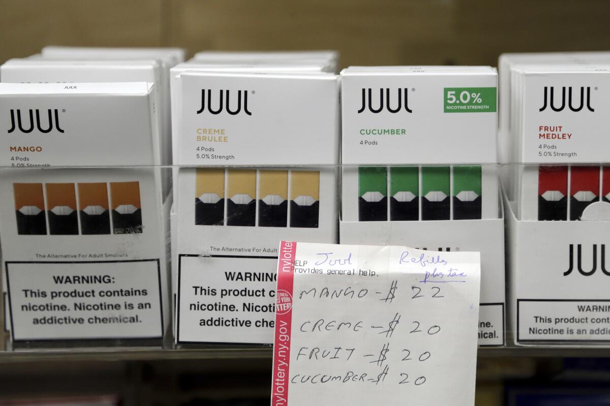 Boxes of Juul vaping pods with various flavors.